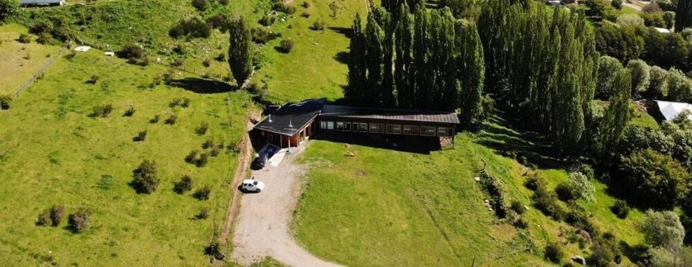 Aerial view of the lodge building with a green roof