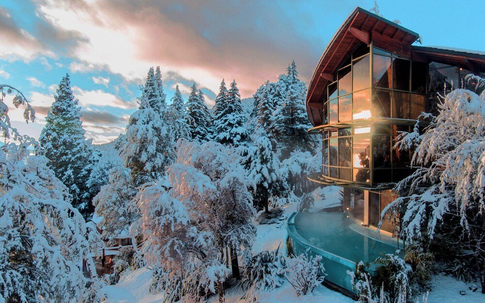 Modern cabin with a glass-enclosed living area at Design Suites Bariloche