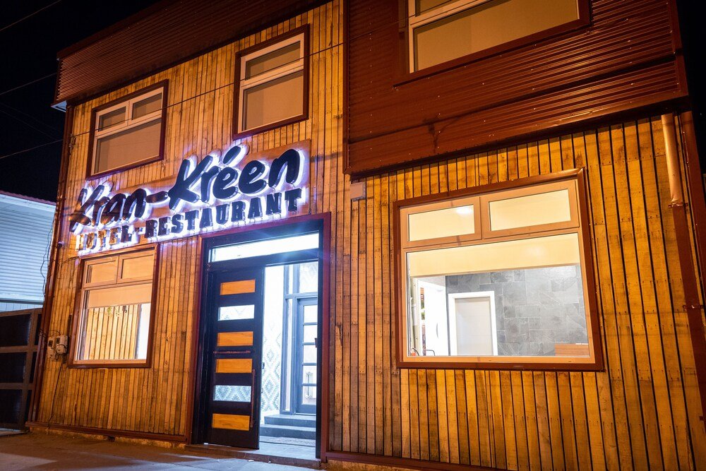 Wooden building with a sign outside Hotel Boutique Kran Kreen