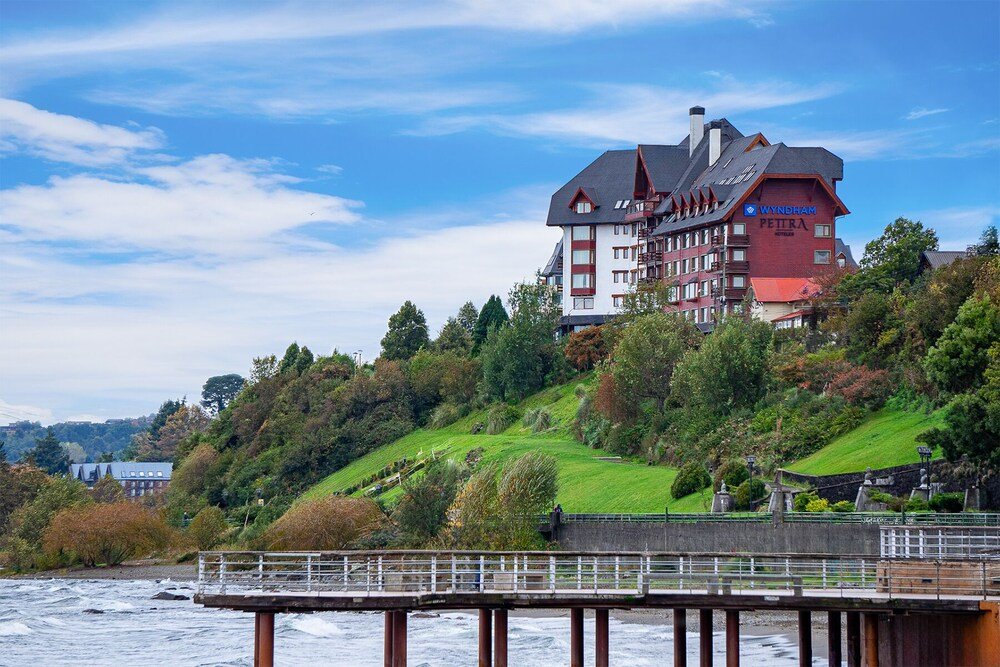 Hotel facade in red and white tones by the lake