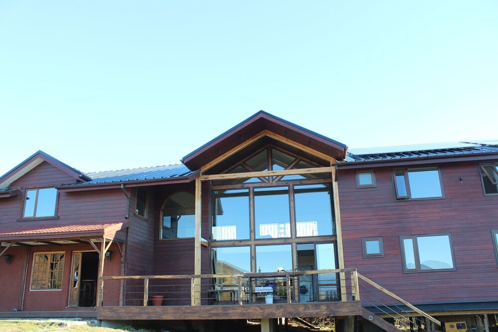 Exterior of the two-story wooden house at Morrena Lodge