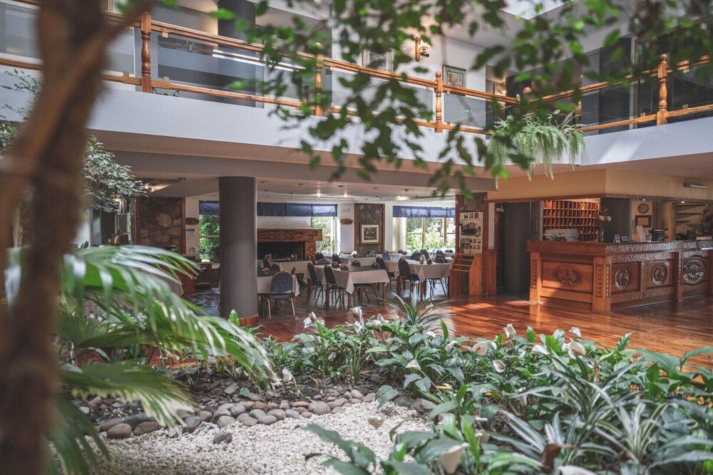 Spacious indoor area with a wooden ceiling at the hotel